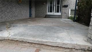 Old Carpet Hides Cracking on Front Porch in Orillia, Ontario