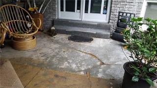 Old Carpet Hides Cracking on Front Porch in Orillia, Ontario