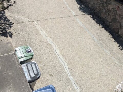 Sealed winding crack across a Toronto concrete driveway