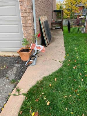 Settled concrete walkway beside a Georgetown home before concrete lifting