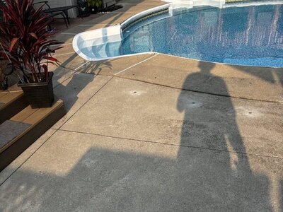 Stoney Creek concrete pool deck beside an in-ground pool after polyurethane concrete lifting