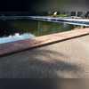 The larger slabs had settled away from the concrete trim that sits along the edge of the pool