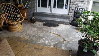 Old Carpet Hides Cracking on Front Porch in Orillia, Ontario