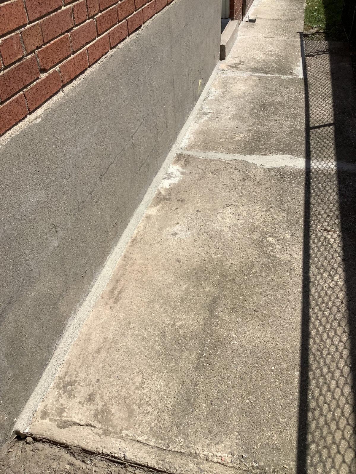 Completed and sealed concrete walkway repair beside a North York home