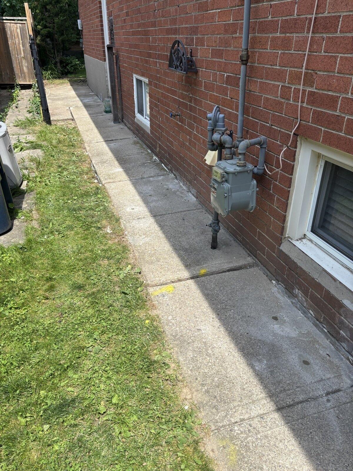 North York walkway slabs lifted with polyurethane injection to restore elevation and drainage